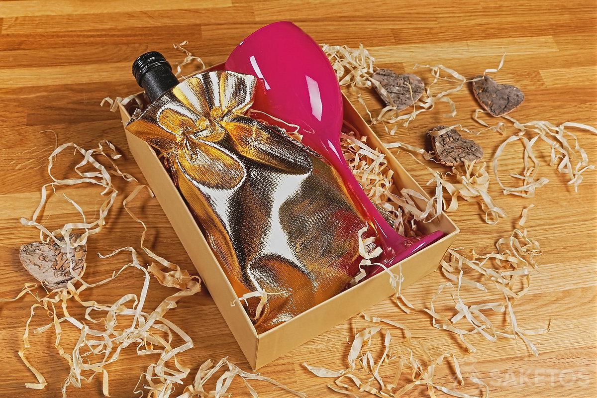Confezione regalo con vino e un bicchiere rosa per la festa della donna
